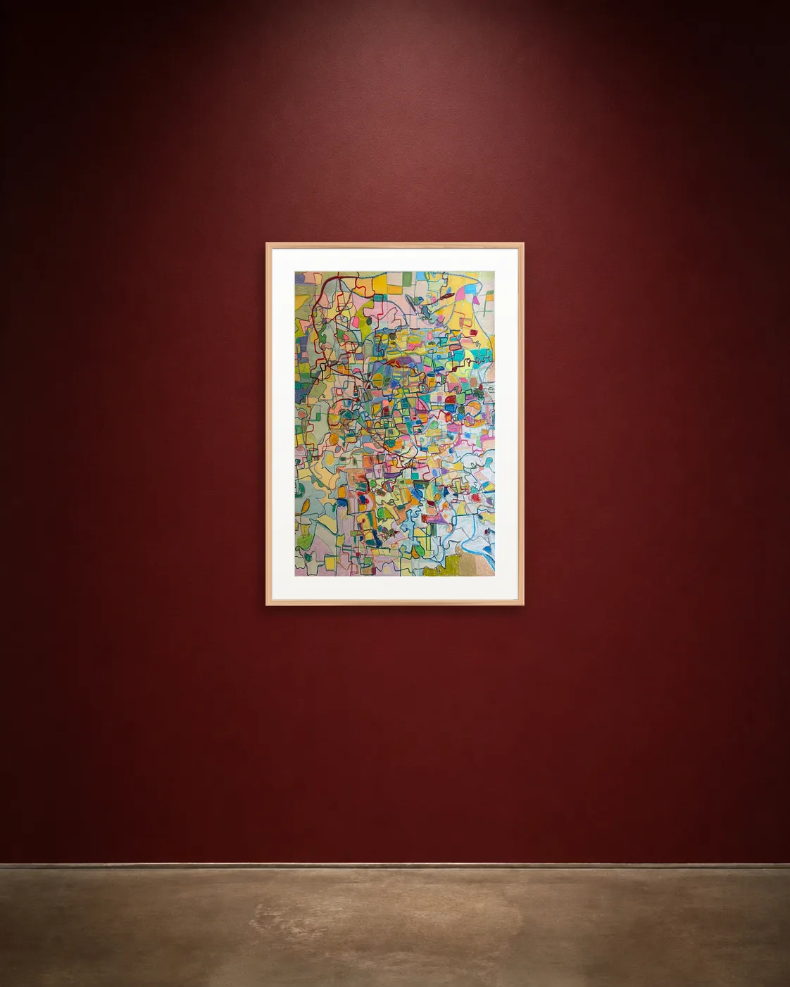 Cartographic Bloom shown framed on a burgundy wall
