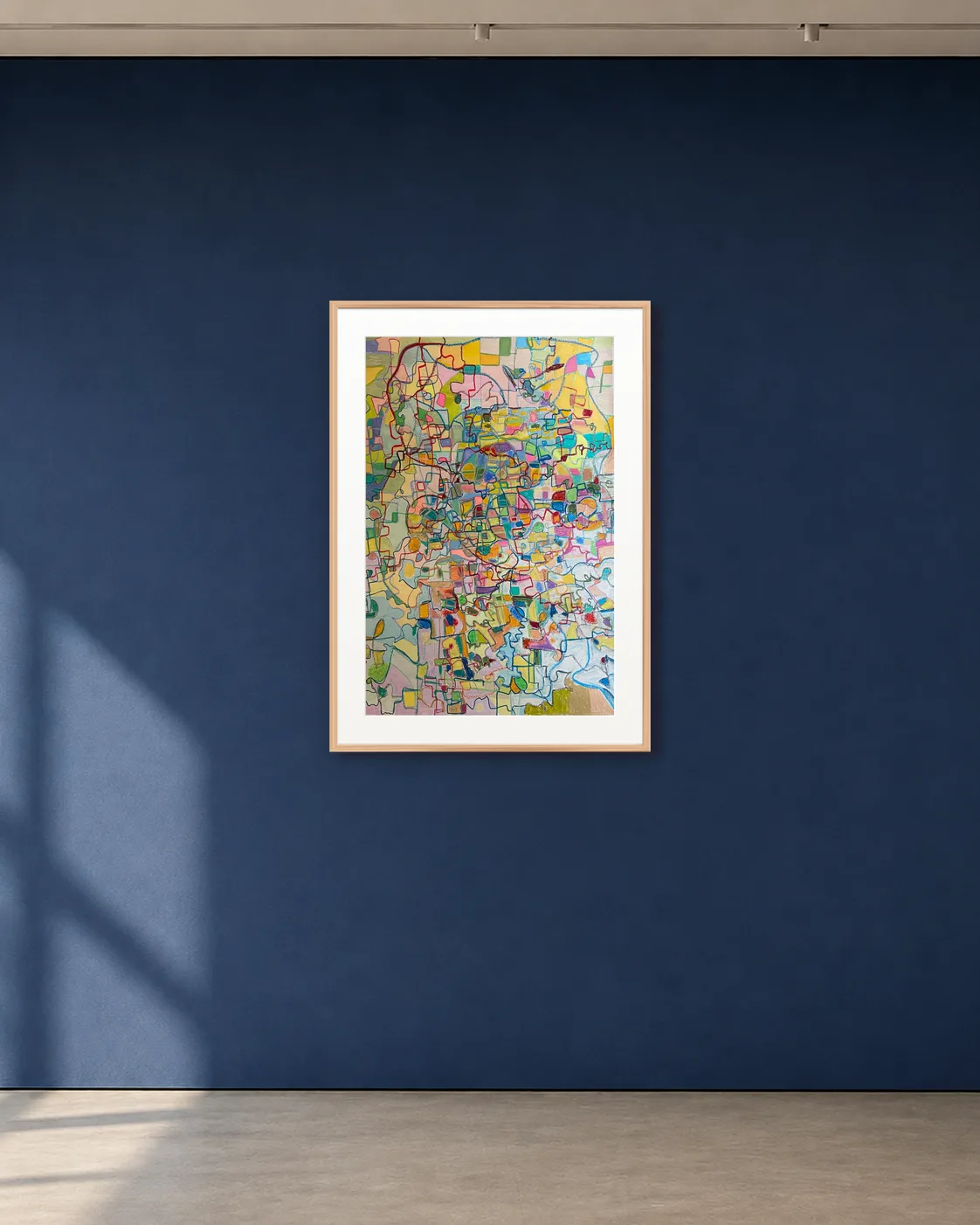 Cartographic Bloom shown framed on a deep blue gallery wall